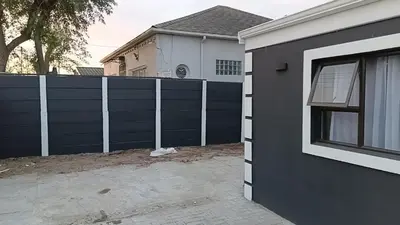 a black fence in front of a house at Spring forth guest house in De Grendel