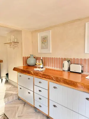 a kitchen with white cabinets and a counter top at Grande Casa - Central Stellenbosch in Stellenbosch
