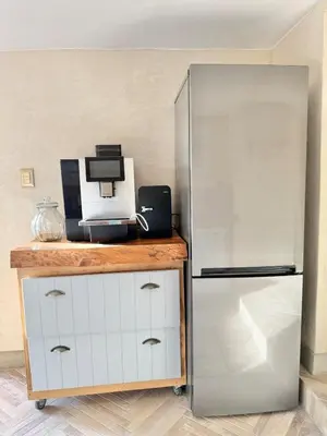 a kitchen with a refrigerator and a microwave at Grande Casa - Central Stellenbosch in Stellenbosch