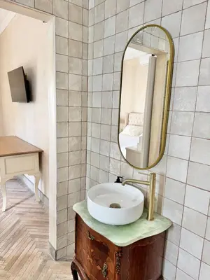 a bathroom with a sink and a mirror at Grande Casa - Central Stellenbosch in Stellenbosch