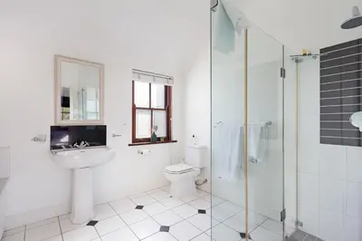 a bathroom with a sink and a toilet and a shower at Winelands Golf Lodges 1 in Onder-Papegaaiberg