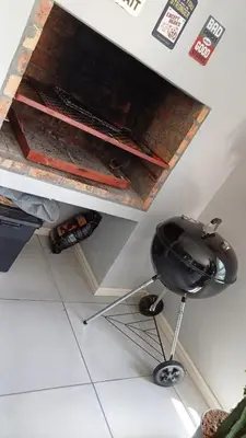 a kitchen with a grill under a counter at Sozo - our place at the ocean in Gordonʼs Bay