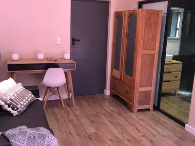 a bedroom with a desk and a dresser and a bed at Modern, Comfy Guest Suite with Beautiful Views in Welgemoed in Tygerberg Hills