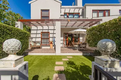 an exterior view of a house with a yard at Holly Tree Franschhoek Accommodation in Franschhoek
