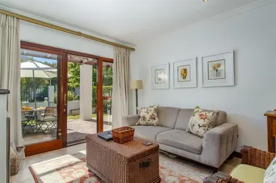 a living room with a couch and a table at Holly Tree Franschhoek Accommodation in Franschhoek