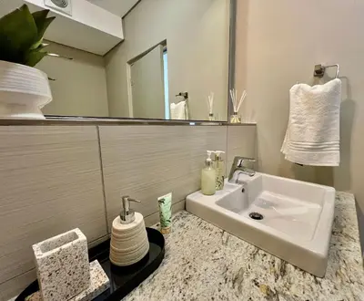 a bathroom with a sink and a mirror at Stay at Andringa Walk Luxury Apartment in Stellenbosch