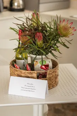 a basket of easter eggs and flowers on a table at Hillside Hideaways - With Pool in Hermanus