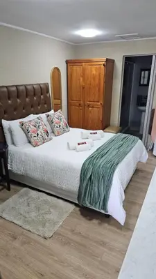 a bedroom with a large bed with two towels on it at Victoria's Rest in Windsor Park