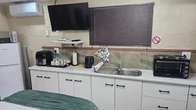 a kitchen with a sink and a microwave at Victoria's Rest in Windsor Park