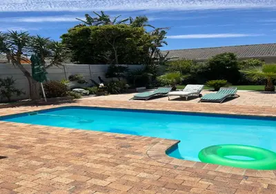 a swimming pool with a frisbee in the middle at Modern Studio with Pool, 5 mins from Beach in Cape Town