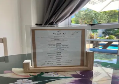 a menu in a display case in a window at Modern Studio with Pool, 5 mins from Beach in Cape Town
