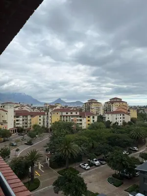 a view of a city with buildings and palm trees at Century City Studio with Table Mountain Views in Cape Town