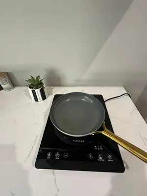 a frying pan sitting on top of a stove at The Perfect Stay Somerset 1 in Somerset West