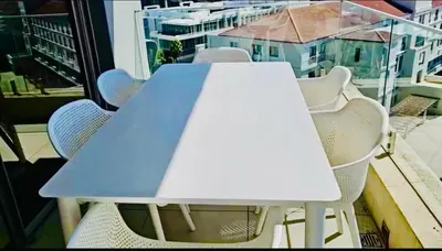 a blue table and chairs on a balcony at Luxury Penthouse -Crystal Towers in Cape Town