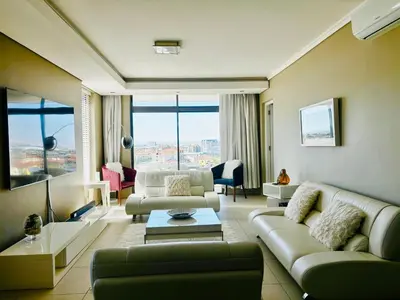 a living room with a couch and a table at Luxury Penthouse -Crystal Towers in Cape Town
