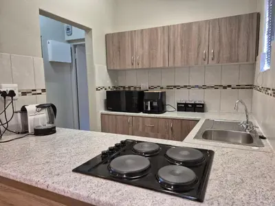 a kitchen counter with a stove top in a kitchen at Mistys Apartment Durbanville in Durbanville