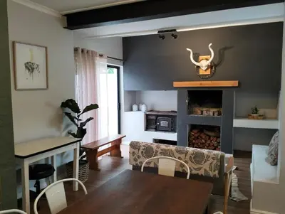 a living room with a couch and a fireplace at Dawson78 in Hermanus