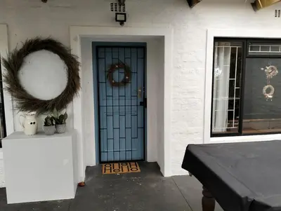 a front door of a house with a wreath on it at Dawson78 in Hermanus