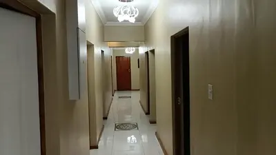 a hallway with a long corridor with a corridorngthngthngthngthngthngthngth at Spring forth guest house in De Grendel