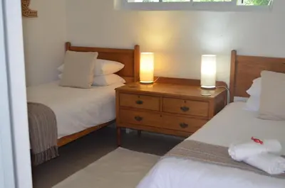 a bedroom with two beds and two lights on a night stand at Stellenhof Inn - walking distance to town center in Stellenbosch