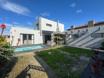 a house with a swimming pool in the yard at Spacious Shared 3-Bedroom Villa Near Bloubergstrand Beach with Pool & Free Wi-Fi in Cape Town