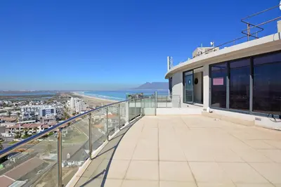 a balcony of a building with a view of the ocean at Aquarius 2 Bedroom Luxury Apartment in Cape Town