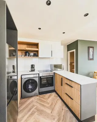 a kitchen with a washer and dryer at Bethany Apartment ON PARK Century City in Cape Town