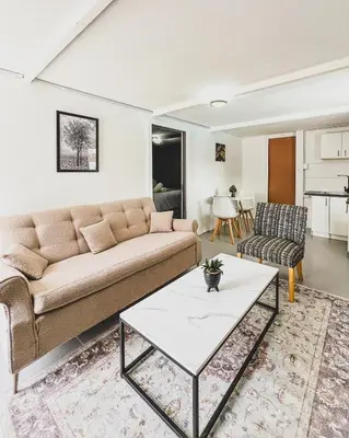 a living room with a couch and a table at Cedar Apartments on Century City in Cape Town