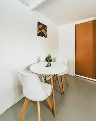 a white table and chairs in a room at Cedar Apartments on Century City in Cape Town