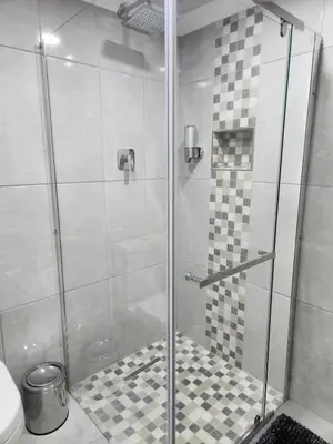 a shower stall with a glass door in a bathroom at Cosy Nook in Cape Town