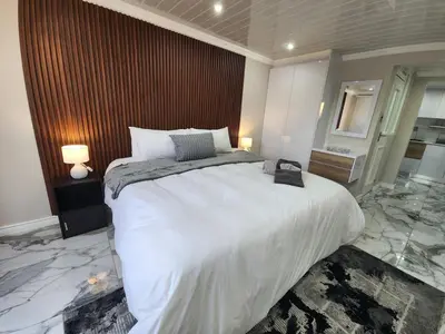 a bedroom with a large white bed in a room at Cosy Nook in Cape Town