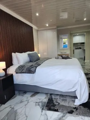 a bedroom with a large white bed in a room at Cosy Nook in Cape Town