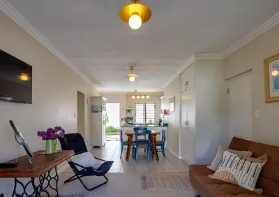 a living room with a couch and a table at Whale - a - While in Hermanus