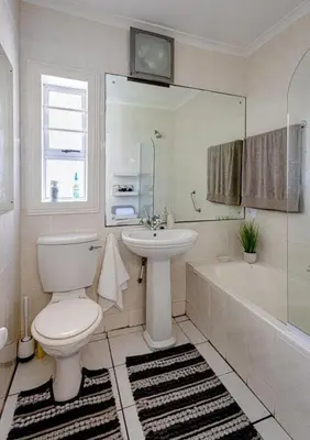 a bathroom with a toilet and a sink and a tub at Whale - a - While in Hermanus