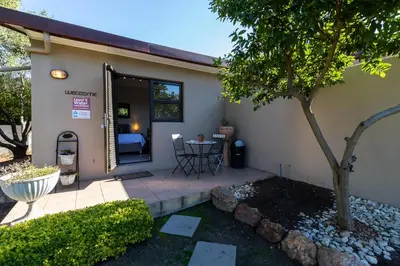 a house with a patio with a table and a tree at Tyger Classique Self-Catering Cape Town, Tyger Valley in Bellville