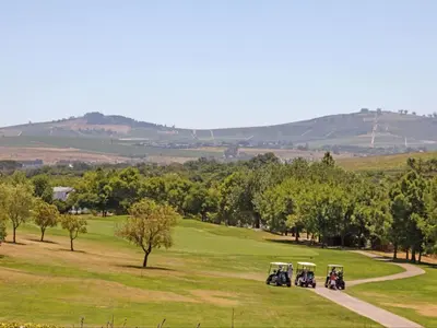 a group of four motorcycles parked on a golf course at Winelands Golf Lodges 8 in Stellenbosch