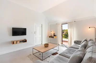 a living room with a couch and a table at Winelands Golf Lodges 8 in Stellenbosch