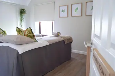 a bed with pillows on it in a room at Winelands Golf Lodges 13 in Stellenbosch