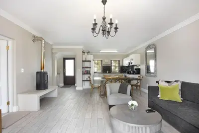 a living room with a couch and a table at Winelands Golf Lodges 17 in Stellenbosch