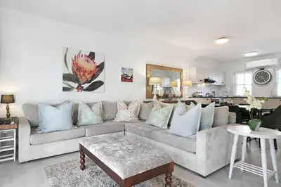 a living room with a couch and a table at Winelands Golf Lodges 22 in Stellenbosch