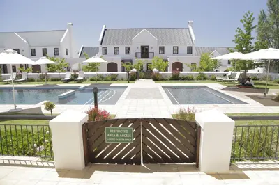 a gate in front of a building with a pool at Winelands Golf Lodges 22 in Stellenbosch