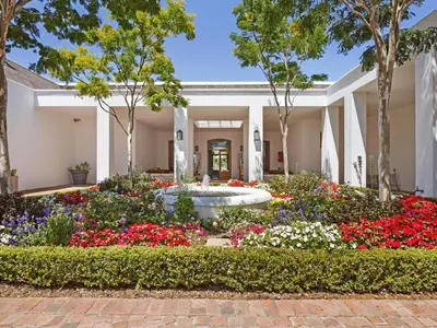 a garden in front of a building with flowers at Winelands Golf Lodges 37 in Stellenbosch