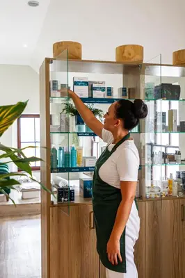 a woman standing in front of a glass case at Winelands Golf Lodges 38 in Stellenbosch