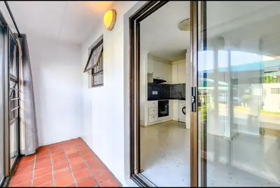 a glass door leading to a kitchen in a house at One Bedroom Loevenstein in Tygerberg Hills