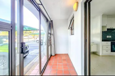 a hallway of a building with a glass door at One Bedroom Loevenstein in Tygerberg Hills