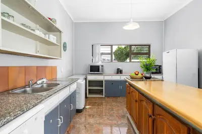 a kitchen with a sink and a refrigerator at The Kleinmond Cottage in Kleinmond