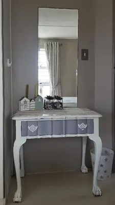 a dressing table in front of a mirror at Strandloper Apartments in Hermanus