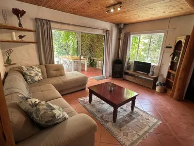 a living room with a couch and a coffee table at Nature Lover's Home in Grabouw in Grabouw