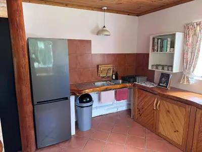 a small kitchen with a refrigerator and a sink at Nature Lover's Home in Grabouw in Grabouw