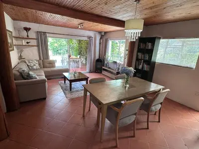 a living room with a wooden table and chairs at Nature Lover's Home in Grabouw in Grabouw